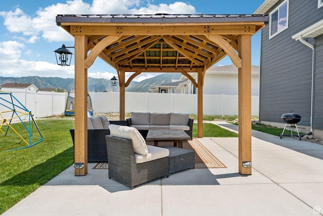 579 E Kings Lndg, Tooele, UT 84074 - fenced backyard featuring a mountain view, an outdoor hangout area, a gazebo, and a patio