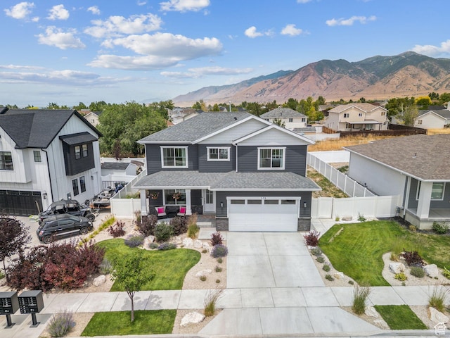 579 E Kings Lndg, Tooele, UT 84074 - view of front of home featuring driveway, a garage, a mountain view, a residential view, and stone siding