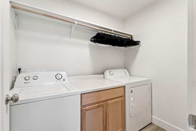 579 E Kings Lndg, Tooele, UT 84074 - laundry room with separate washer and dryer, light wood-type flooring, and cabinet space