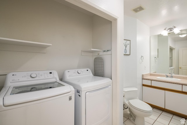 542 W Hale Ave, Moab, UT 84532 - washroom with washer and clothes dryer and light tile patterned flooring