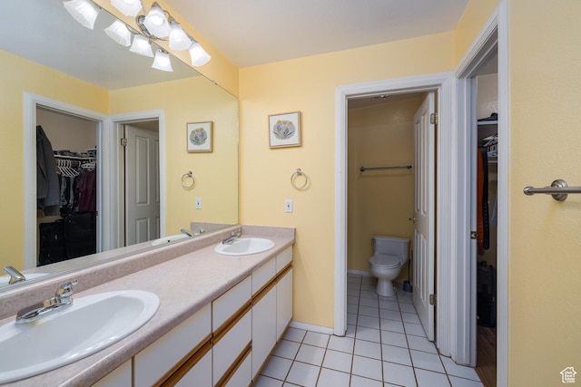 542 W Hale Ave, Moab, UT 84532 - bathroom featuring double vanity, a spacious closet, and tile patterned flooring