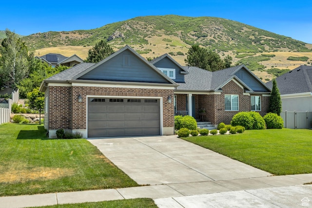 1668 N 400 W, Farmington, UT 84025 - view of front of home with a garage, concrete driveway, brick siding, and a mountain view