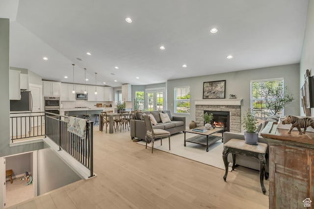1668 N 400 W, Farmington, UT 84025 - living area with recessed lighting, light wood-style flooring, and a stone fireplace