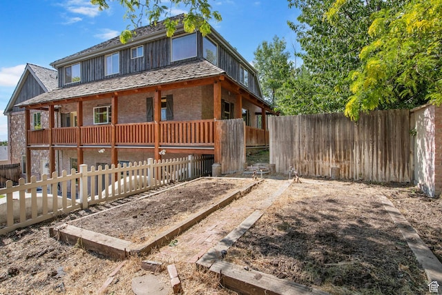 924 Redford Dr, Provo, UT 84604 - view of front of house featuring brick siding, a vegetable garden, and a fenced backyard