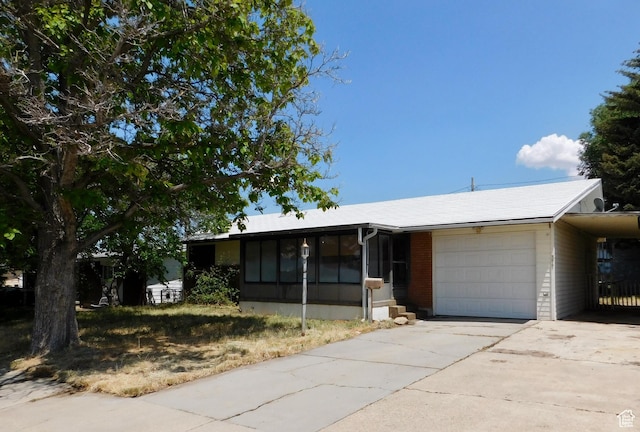 377 S 400 W, Tooele, UT 84074 - single story home with concrete driveway, a sunroom, and an attached garage