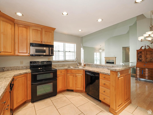 6948 S 855 E, Midvale, UT 84047 - kitchen with black appliances, a peninsula, recessed lighting, light stone countertops, and vaulted ceiling