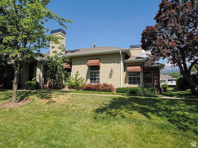 6948 S 855 E, Midvale, UT 84047 - ranch-style home featuring a chimney, a front yard, and stucco siding