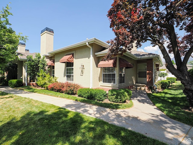 6948 S 855 E, Midvale, UT 84047 - ranch-style home featuring a front lawn, a chimney, and stucco siding