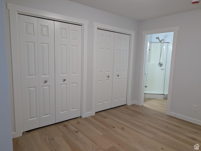 623 S 500 W Unit 17, Provo, UT 84601 - unfurnished bedroom with multiple closets, light wood-style floors, and connected bathroom