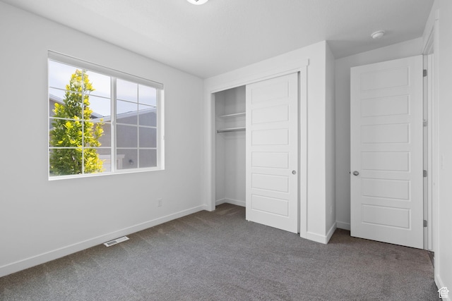 6856 W 8060 S, West Jordan, UT 84081 - unfurnished bedroom featuring dark colored carpet, multiple windows, and a closet