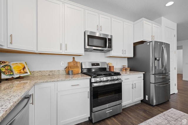 6856 W 8060 S, West Jordan, UT 84081 - kitchen with appliances with stainless steel finishes, dark wood finished floors, white cabinetry, and light stone counters