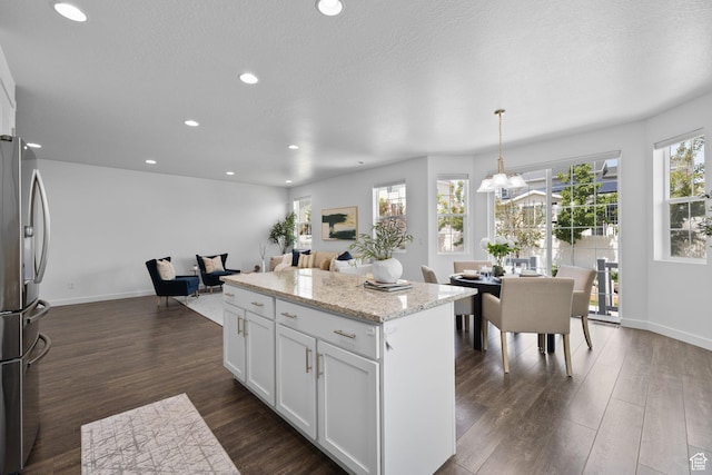 6856 W 8060 S, West Jordan, UT 84081 - kitchen with stainless steel fridge, a center island, white cabinetry, recessed lighting, and dark wood-type flooring