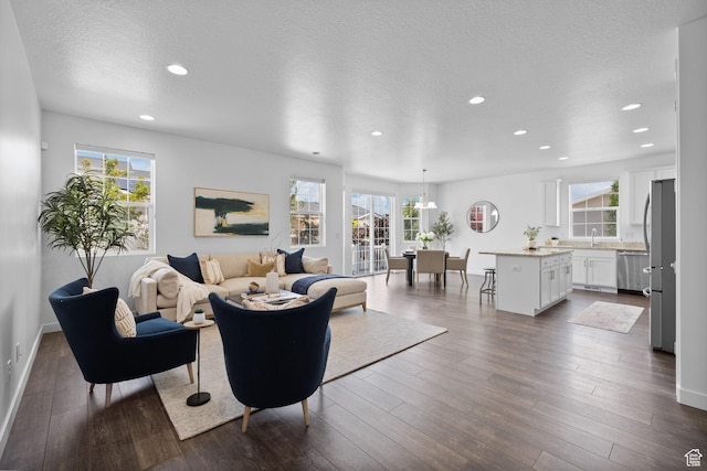 6856 W 8060 S, West Jordan, UT 84081 - living area with recessed lighting, dark wood-style flooring, and a textured ceiling
