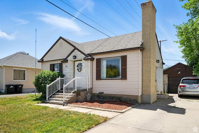 350 E 800 N, Spanish Fork, UT 84660 - bungalow-style home with a chimney, a front yard, a shingled roof, and concrete driveway