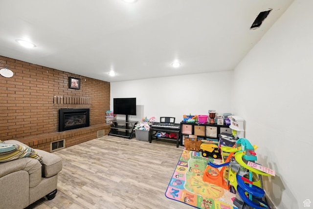 350 E 800 N, Spanish Fork, UT 84660 - recreation room featuring a fireplace, wood finished floors, brick wall, and recessed lighting