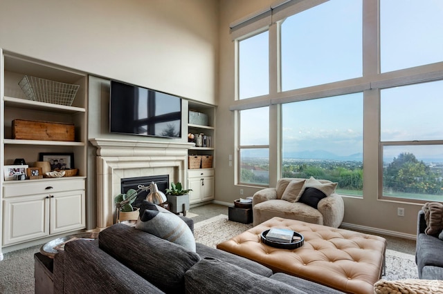 4179 W Sandalwood Dr, Cedar Hills, UT 84062 - living room featuring light colored carpet, healthy amount of natural light, a glass covered fireplace, and a towering ceiling