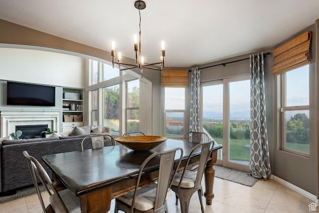 4179 W Sandalwood Dr, Cedar Hills, UT 84062 - dining space featuring a chandelier, healthy amount of natural light, a fireplace, and light tile patterned floors