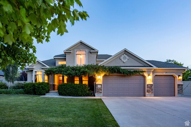 4179 W Sandalwood Dr, Cedar Hills, UT 84062 - view of front facade featuring a garage, stone siding, concrete driveway, and a front lawn