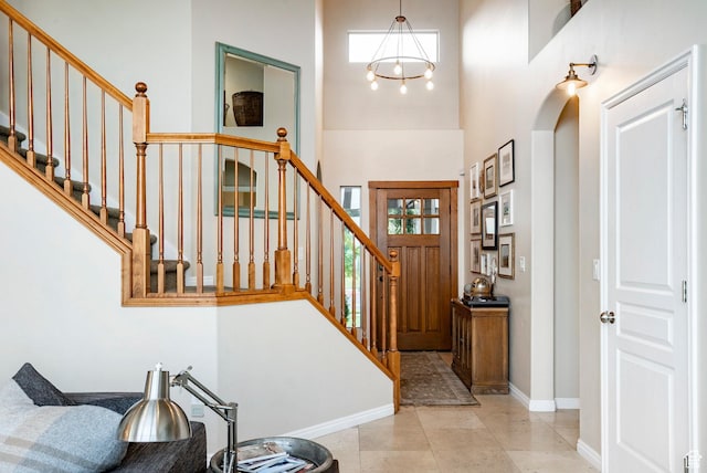 4179 W Sandalwood Dr, Cedar Hills, UT 84062 - foyer featuring a high ceiling, stairway, a chandelier, and arched walkways