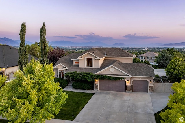 4179 W Sandalwood Dr, Cedar Hills, UT 84062 - view of front of house featuring a gate, an attached garage, driveway, stone siding, and roof with shingles