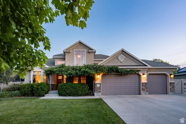 4179 W Sandalwood Dr, Cedar Hills, UT 84062 - view of front facade with stucco siding, stone siding, a front yard, concrete driveway, and a garage