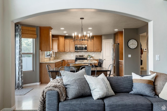 4179 W Sandalwood Dr, Cedar Hills, UT 84062 - living area featuring arched walkways, a chandelier, recessed lighting, and light tile patterned floors