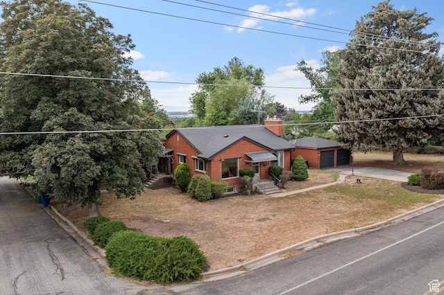 2335 Fillmore Ave, Ogden, UT 84401 - view of front facade featuring concrete driveway, brick siding, and a chimney