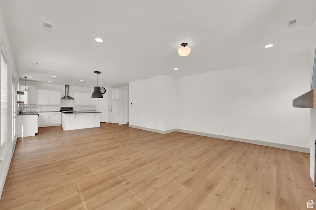 4961 E Oakwood Dr, Eagle Mountain, UT 84005 - unfurnished living room featuring recessed lighting and light wood-type flooring