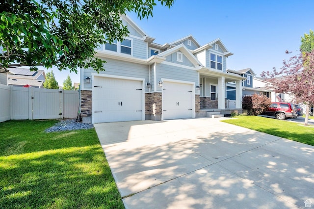 4961 E Oakwood Dr, Eagle Mountain, UT 84005 - craftsman house featuring driveway, a gate, stone siding, and a garage