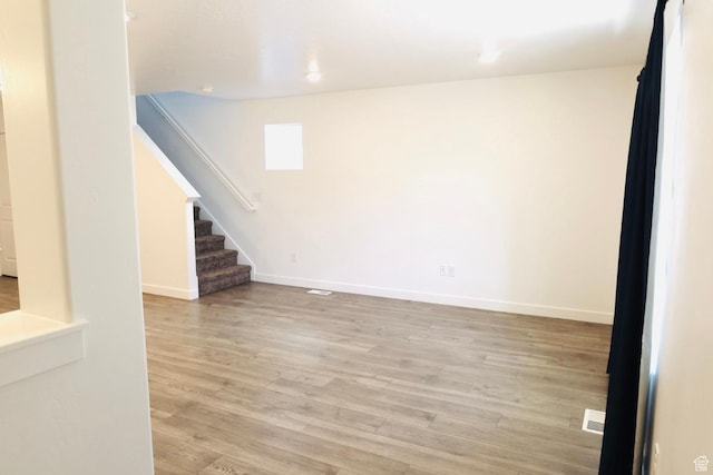 54 N Heading Row, Saratoga Springs, UT 84045 - unfurnished living room with light wood-type flooring and stairway