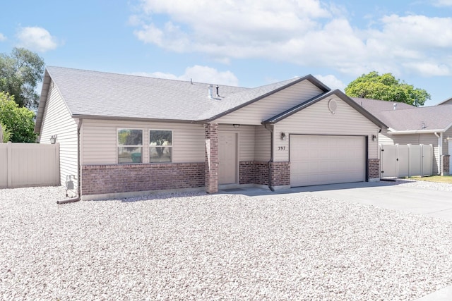 397 Old Springs Rd, Ogden, UT 84404 - view of front of house with brick siding, an attached garage, concrete driveway, and roof with shingles