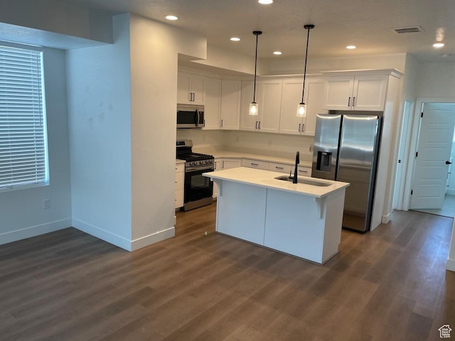 136 E Abbeville Ct, Sandy, UT 84070 - kitchen with appliances with stainless steel finishes, white cabinets, light countertops, dark wood finished floors, and recessed lighting