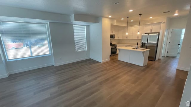 136 E Abbeville Ct, Sandy, UT 84070 - kitchen featuring stainless steel appliances, white cabinets, a center island with sink, light countertops, and open floor plan