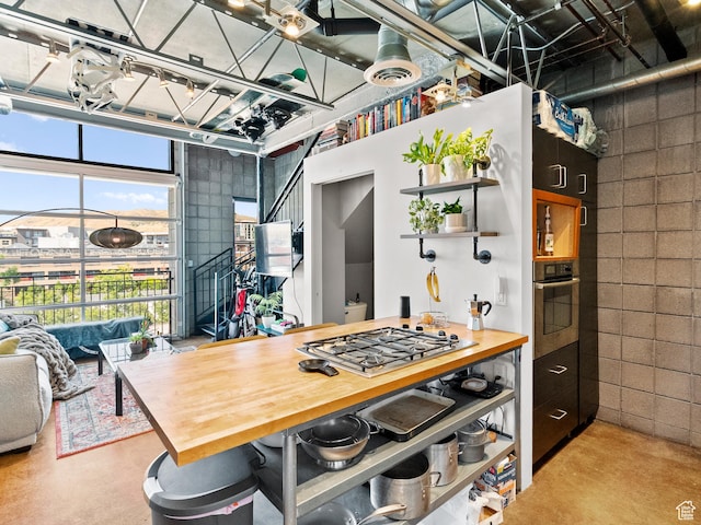 360 W Broadway S Unit 619, Salt Lake City, UT 84101 - kitchen featuring appliances with stainless steel finishes, concrete flooring, wood counters, and open shelves