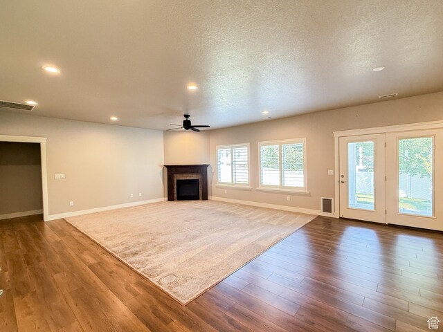 1302 E Mary Ln, Layton, UT 84040 - unfurnished living room featuring ceiling fan, recessed lighting, a fireplace, wood finished floors, and a textured ceiling