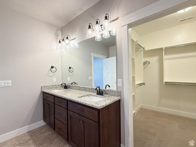 1302 E Mary Ln, Layton, UT 84040 - full bath with double vanity, a spacious closet, and a textured ceiling