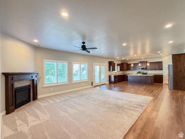 1302 E Mary Ln, Layton, UT 84040 - unfurnished living room featuring recessed lighting, ceiling fan, a fireplace, and light wood-style floors