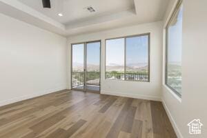 2140 W 320 S Unit 48-51, Hurricane, UT 84737 - empty room featuring a raised ceiling, healthy amount of natural light, and wood finished floors