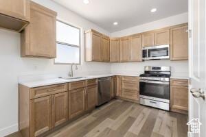 2140 W 320 S Unit 48-51, Hurricane, UT 84737 - kitchen with appliances with stainless steel finishes, light countertops, light wood-style floors, and recessed lighting