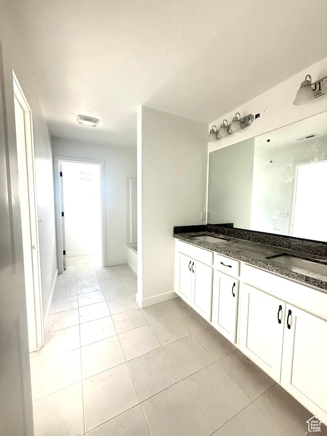 2865 S Ritter Row W Unit 55, West Valley City, UT 84128 - full bathroom with double vanity, a bathtub, tile patterned floors, and a shower