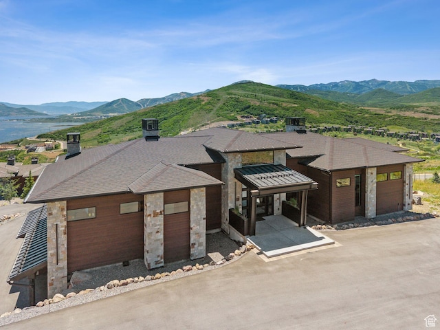 13690 N Deer Canyon Dr, Kamas, UT 84036 - view of front facade featuring a mountain view, stone siding, and a shingled roof