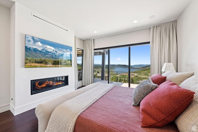 13690 N Deer Canyon Dr, Kamas, UT 84036 - bedroom with wood finished floors, a glass covered fireplace, a water and mountain view, recessed lighting, and access to outside