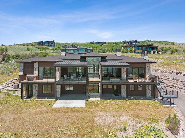 13690 N Deer Canyon Dr, Kamas, UT 84036 - rear view of property featuring a standing seam roof, stone siding, and a metal roof