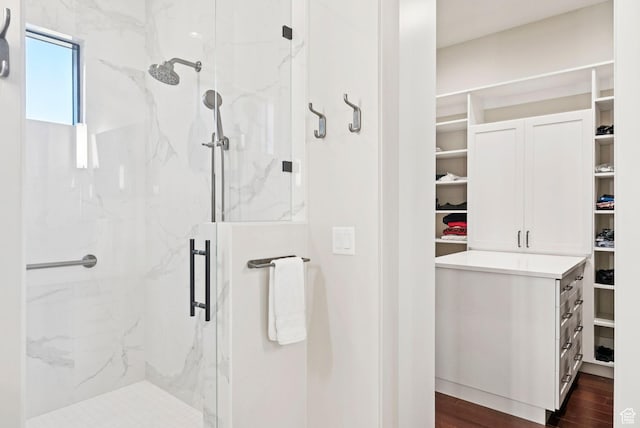 13690 N Deer Canyon Dr, Kamas, UT 84036 - bathroom with a walk in closet, a marble finish shower, and wood finished floors