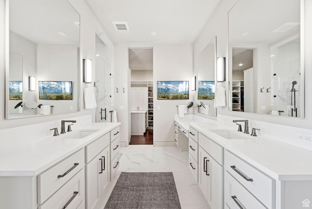 13690 N Deer Canyon Dr, Kamas, UT 84036 - bathroom featuring a walk in closet, two vanities, marble look tiles, a shower stall, and recessed lighting