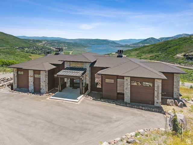 13690 N Deer Canyon Dr, Kamas, UT 84036 - view of front facade featuring a mountain view, stone siding, a chimney, and brick siding