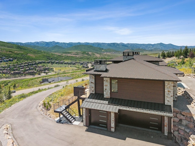13690 N Deer Canyon Dr, Kamas, UT 84036 - view of front of property featuring a standing seam roof, a mountain view, stone siding, and a metal roof