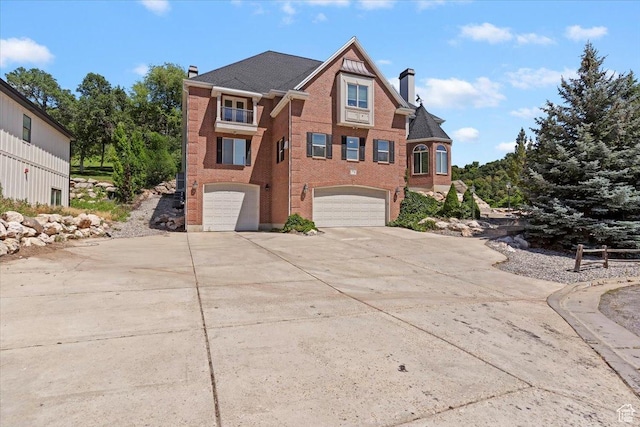 2718 N 2125 E, Layton, UT 84040 - view of front of home with a chimney, an attached garage, concrete driveway, and brick siding