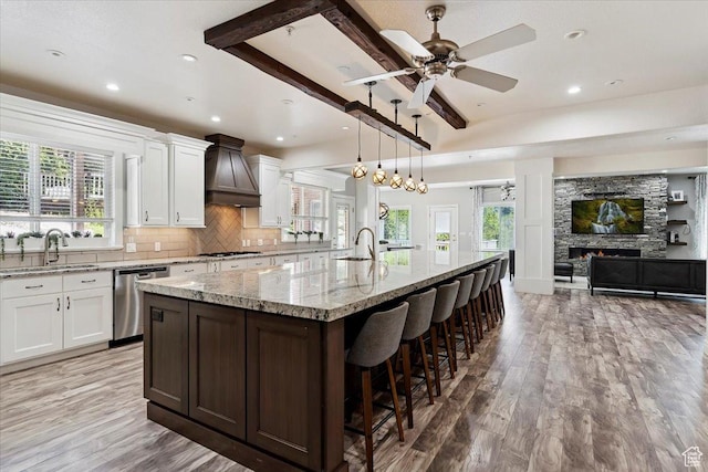 2718 N 2125 E, Layton, UT 84040 - kitchen with stainless steel appliances, custom exhaust hood, a large island with sink, white cabinets, and recessed lighting