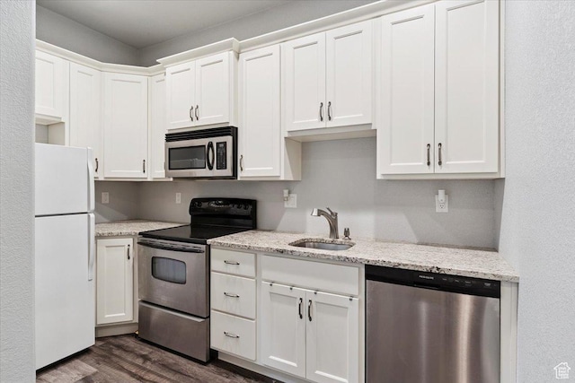 2718 N 2125 E, Layton, UT 84040 - kitchen with stainless steel appliances, dark wood finished floors, white cabinets, and light stone countertops